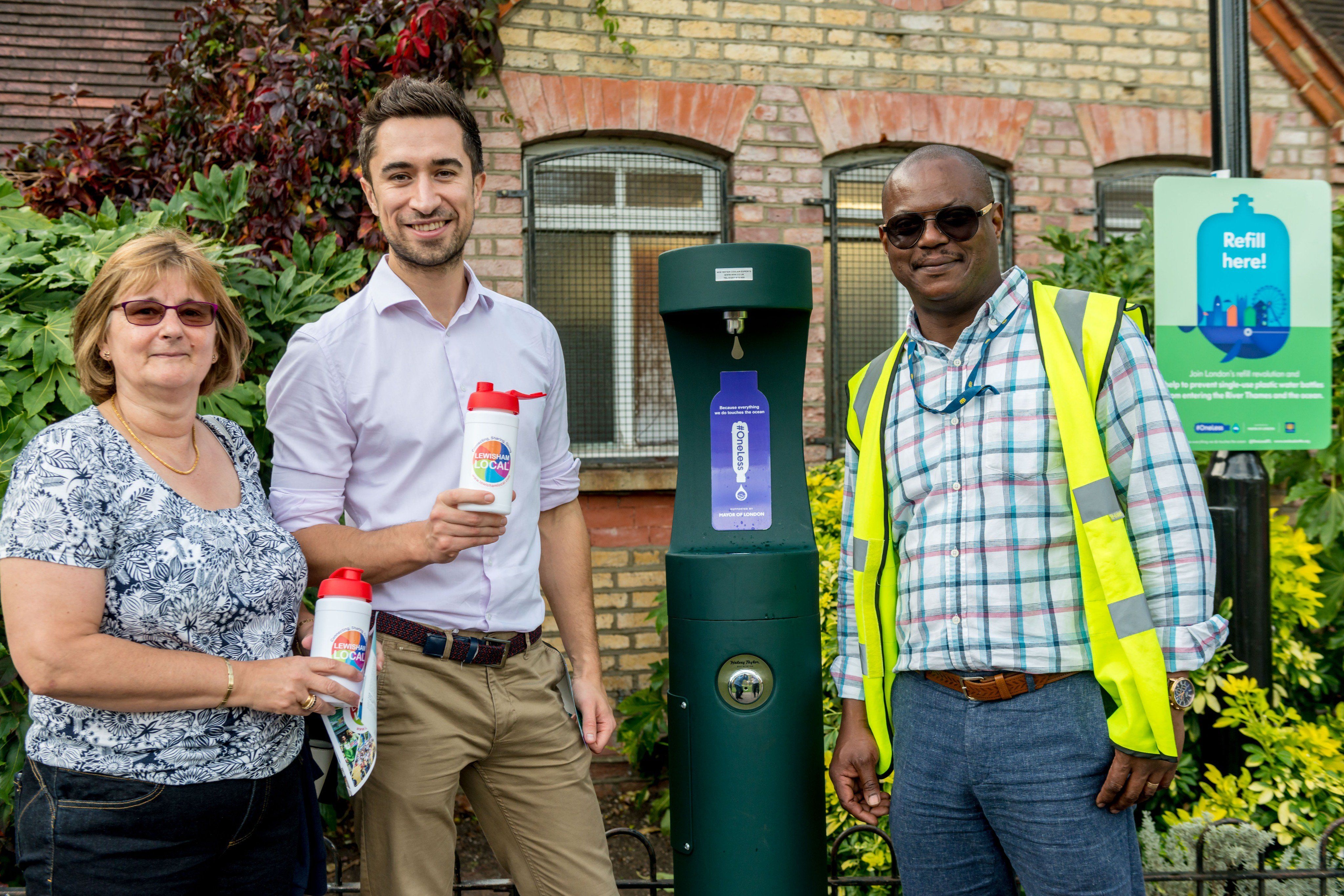 Group of people smiling and posing at the new drinking fountain at Ladywell Fields