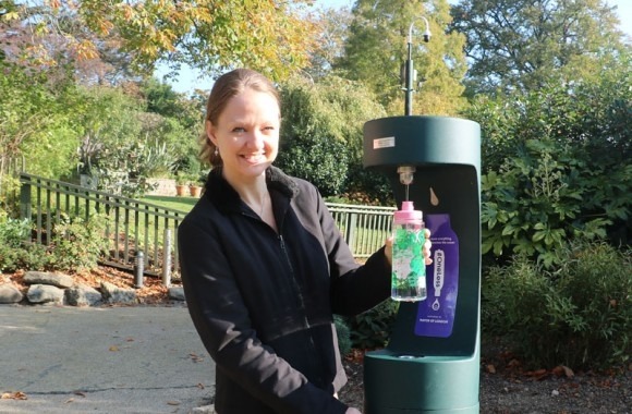 Woman refilling at an outdoor bottle refill station in Horniman Museum and Gardens.