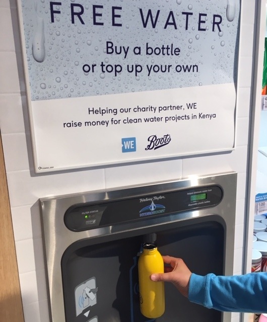 Yellow bottle being refilled at the new bottle filler in Boots.