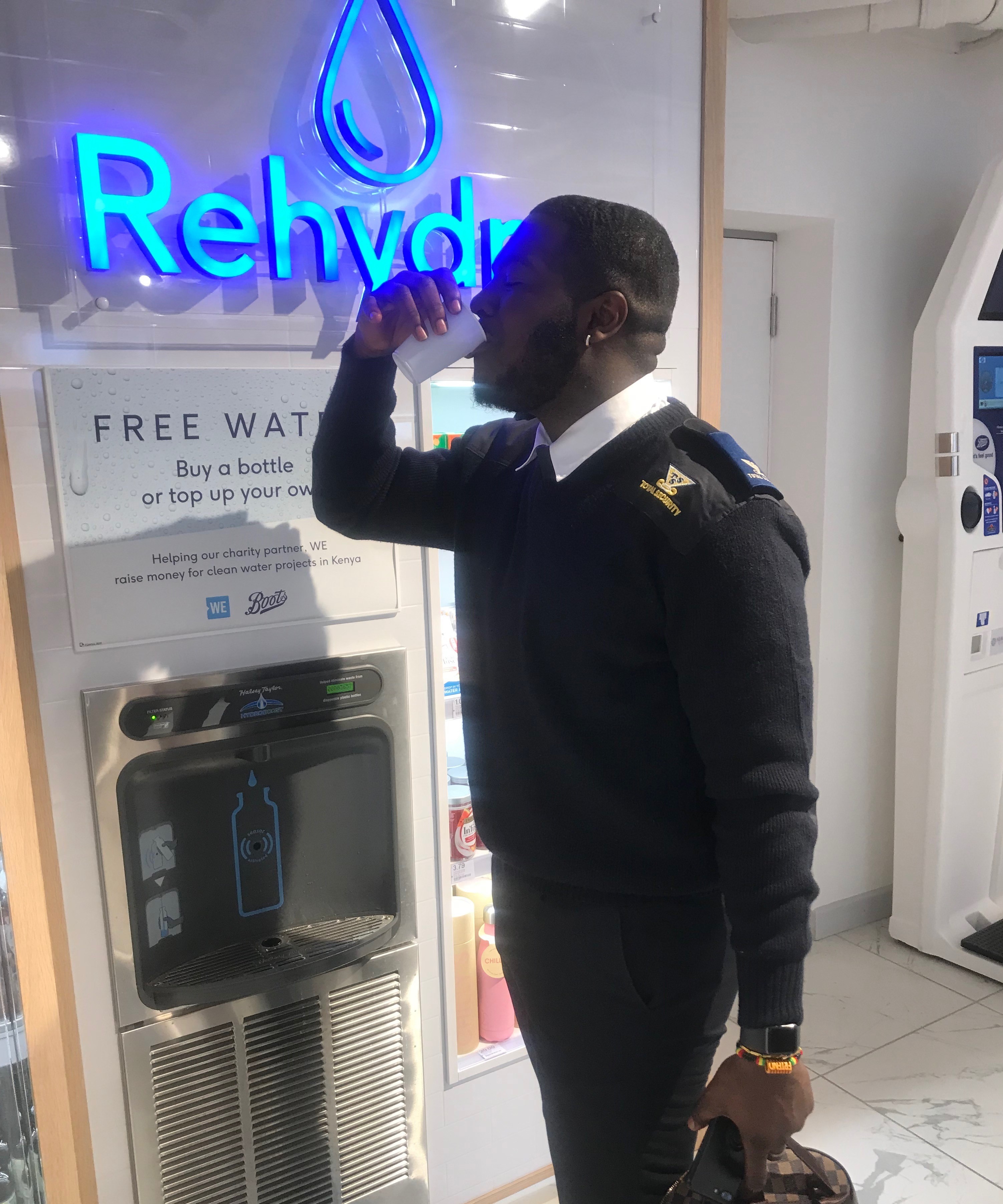Security guard drinking water from the new refill station.