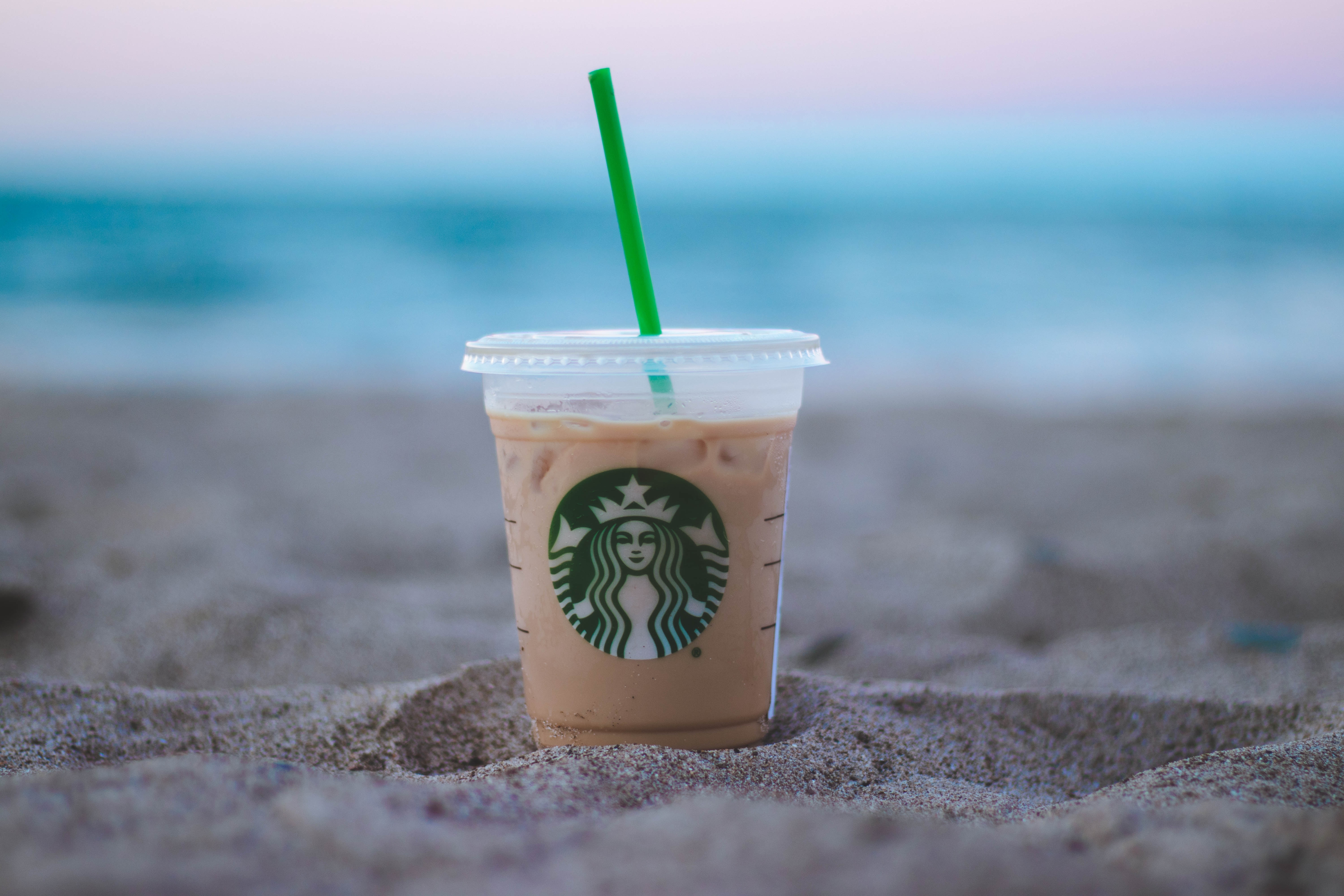 Starbucks coffee cup on the beach.