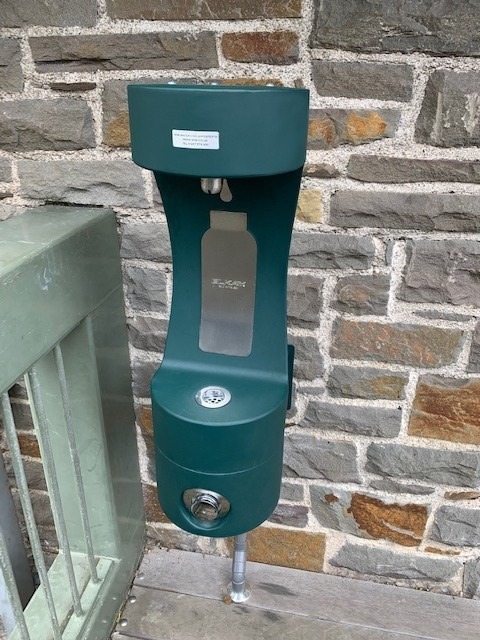 New green outdoor bottle refill station at Conwy Castle.