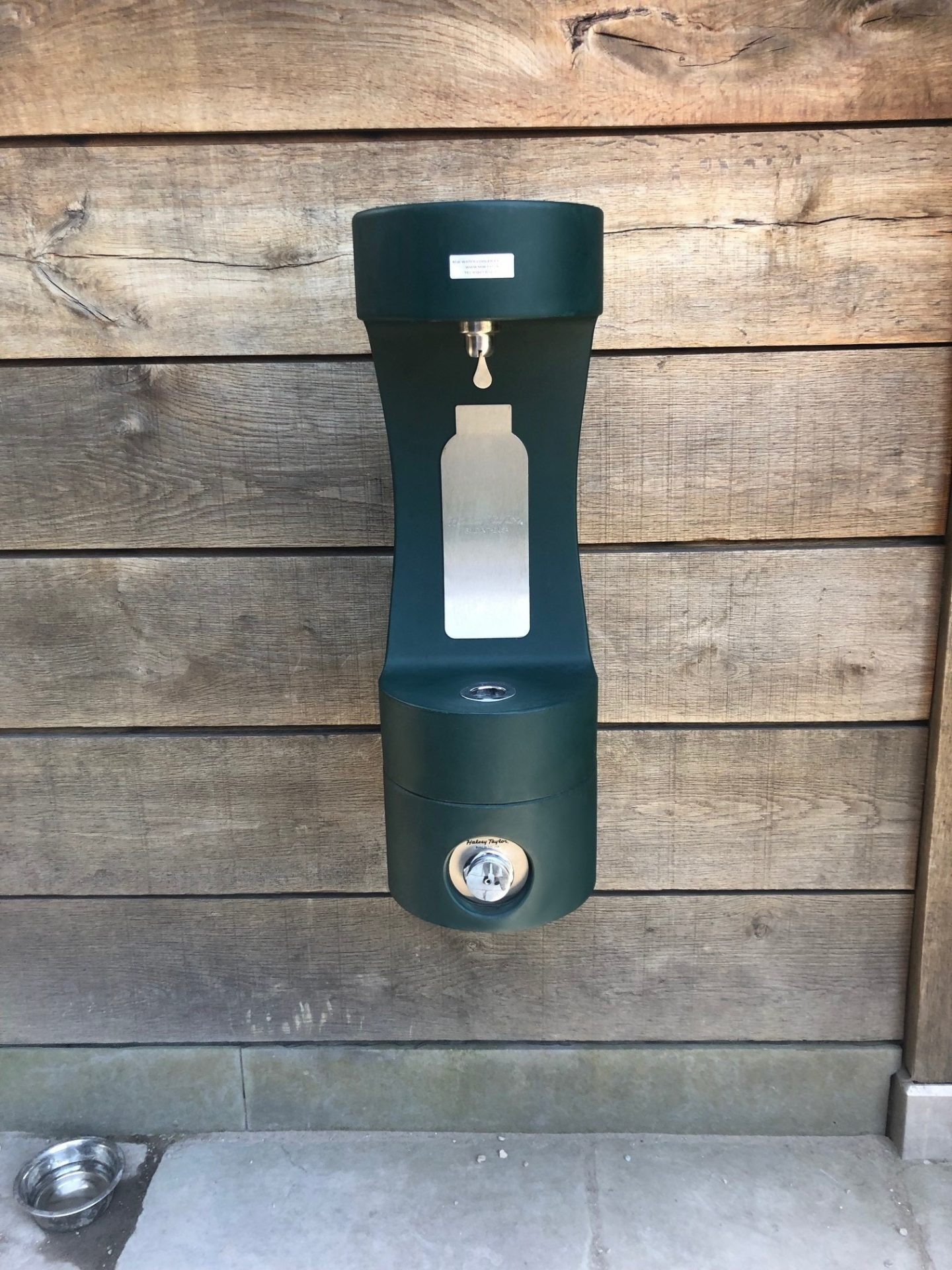 New green wall-mounted bottle filler at Caerphilly Castle