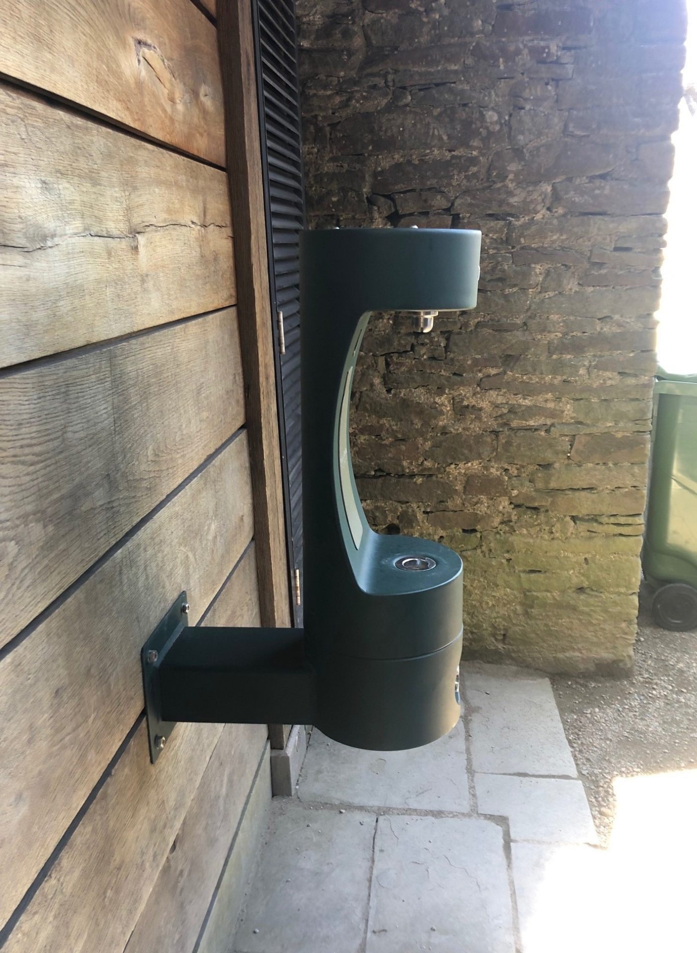 Green drinking fountain on the wall at Caerphilly Castle