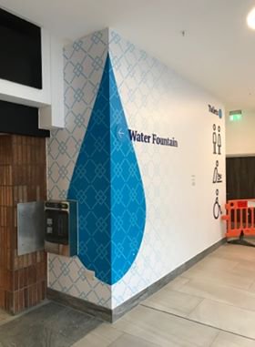 Branded wall near the new drinking fountain in a shopping centre in Bedford